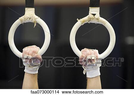Gymnast's hands gripping the rings, cropped View Large Photo Image Picture - Gymnast's hands gripping the rings, cropped. Fotosearch