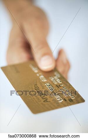 Stock Photo - Hand holding credit card. Fotosearch