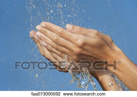 Hands under splashing water View Large Photo Image Stock Image - Hands under splashing water. Fotosearch