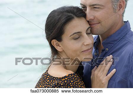 Husband and wife, wife leaning against husband with eyes closed View Large Photo Image Stock Photography - Husband and wife, wife leaning against husband with eyes closed. Fotosearch