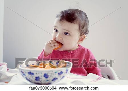 Infant eating carrots, portrait View Large Photo Image Picture - Infant eating carrots, portrait. Fotosearch