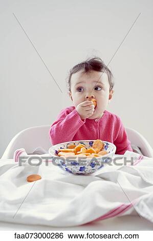 Infant eating carrots, portrait View Large Photo Image Stock Photograph - Infant eating carrots, portrait. Fotosearch