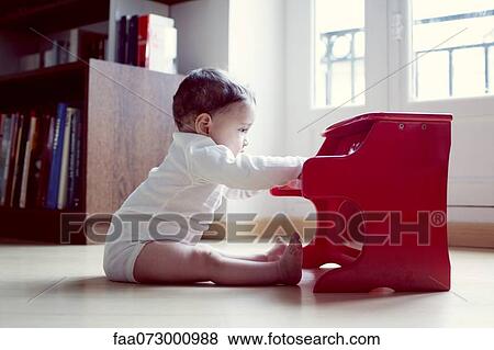 Infant playing with toy piano View Large Photo Image Stock Photo - Infant playing with toy piano. Fotosearch