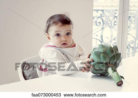 Infant with fresh artichoke View Large Photo Image Stock Image - Infant with fresh artichoke. Fotosearch