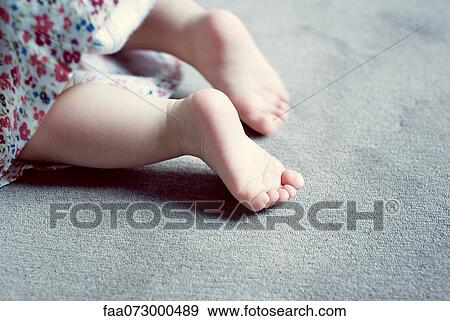 Stock Photo - Legs of baby girl, cropped. Fotosearch