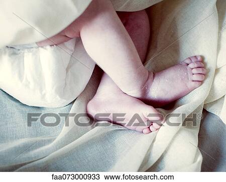 Stock Image - Legs of new born baby, cropped. Fotosearch
