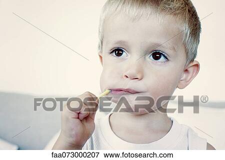 Little boy eating lollipop, portrait View Large Photo Image Stock Photo - Little boy eating lollipop, portrait. Fotosearch