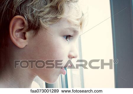 Little boy looking out of window View Large Photo Image Stock Photo - Little boy looking out of window. Fotosearch