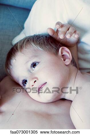 Stock Photography - Little boy resting head on his brother's chest, portrait. Fotosearch