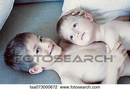 Little boy resting head on older brother's chest, portrait View Large Photo Image Stock Image - Little boy resting head on older brother's chest, portrait. Fotosearch