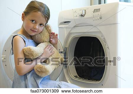 Little girl embracing teddy bear View Large Photo Image Stock Photo - Little girl embracing teddy bear. Fotosearch