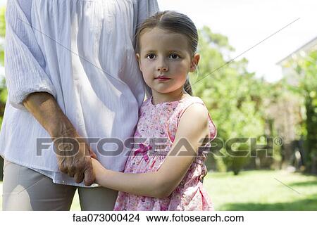 Picture - Little girl holding grandmother's hands, cropped. Fotosearch