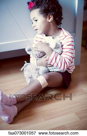 Stock Photo - Little girl holding stuffed toy. Fotosearch