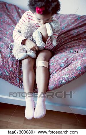 Stock Photo - Little girl holding stuffed toys. Fotosearch