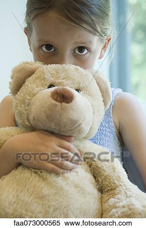 girl hugging stuffed animal