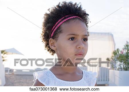 Stock Photo - Little girl looking away, portrait. Fotosearch