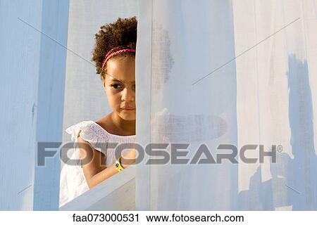 Little girl looking through curtain, portrait View Large Photo Image Stock Image - Little girl looking through curtain, portrait. Fotosearch