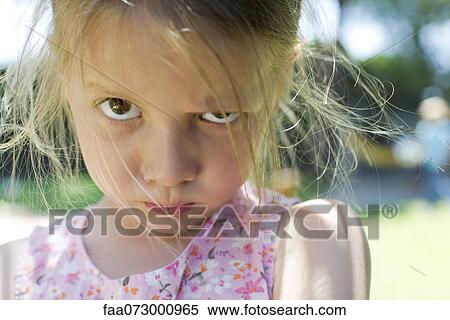 Little girl staring at camera with lips pursed View Large Photo Image Stock Photography - Little girl staring at camera with lips pursed. Fotosearch