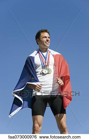Male athlete being honored on podium, wrapped in French flag View Large Photo Image Stock Photograph - Male athlete being honored on podium, wrapped in French flag. Fotosearch