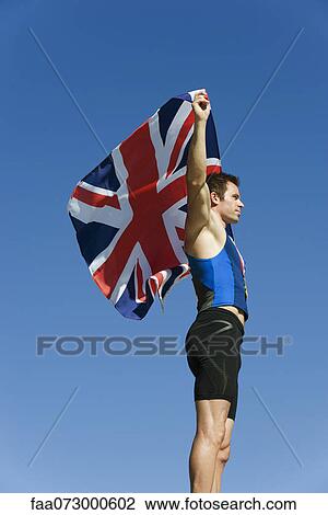 Male athlete holding up British flag View Large Photo Image Stock Image - Male athlete holding up British flag. Fotosearch