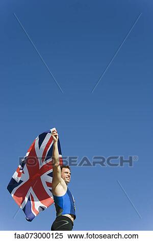 Male athlete holding up British flag View Large Photo Image Stock Photography - Male athlete holding up British flag. Fotosearch