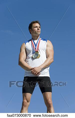 Stock Image - Male athlete on winner's podium. Fotosearch