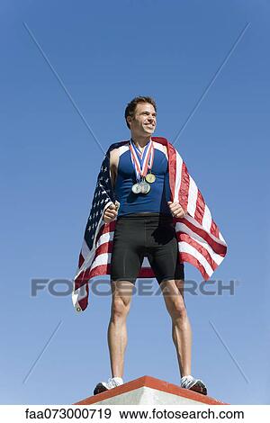 Male athlete on winner's podium, wrapped in American flag View Large Photo Image Stock Photo - Male athlete on winner's podium, wrapped in American flag. Fotosearch