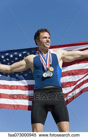 Male athlete on winner's podium, holding up American flag View Large Photo Image Stock Photography - Male athlete on winner's podium, holding up American flag. Fotosearch