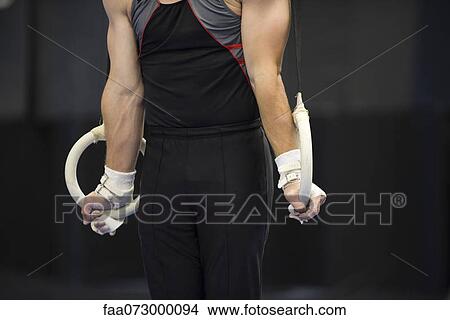 Male gymnast on the rings, cropped View Large Photo Image Picture - Male gymnast on the rings, cropped. Fotosearch