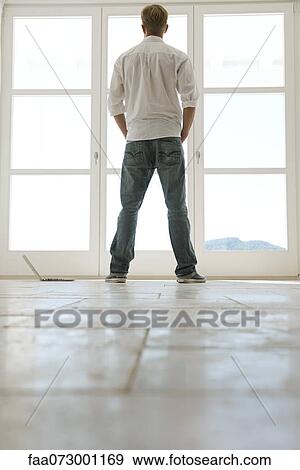 Man looking out window, rear view View Large Photo Image Stock Photo - Man looking out window, rear view. Fotosearch
