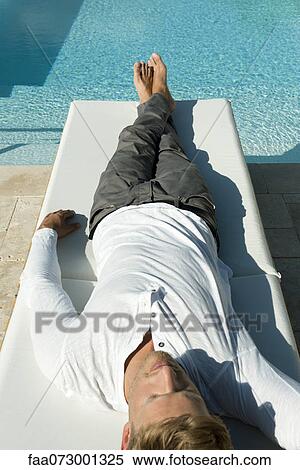 Man napping beside pool View Large Photo Image Stock Photography - Man napping beside pool. Fotosearch