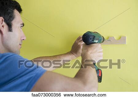 Man using power drill View Large Photo Image Stock Photograph - Man using power drill. Fotosearch