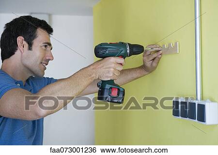 Man using power drill View Large Photo Image Stock Photograph - Man using power drill. Fotosearch