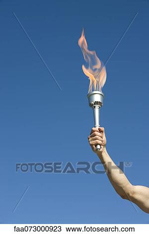 Man's arm holding up torch View Large Photo Image Stock Image - Man's arm holding up torch. Fotosearch