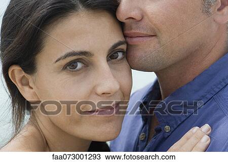 Mid-adult woman hugging husband, cropped View Large Photo Image Stock Image - Mid-adult woman hugging husband, cropped. Fotosearch