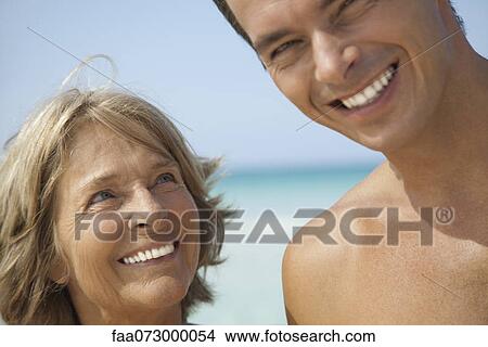 Picture - Mother and adult son at the beach, portrait. Fotosearch
