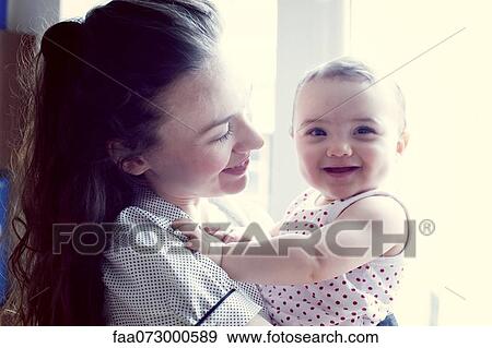 Stock Photo - Mother and baby girl, portrait. Fotosearch