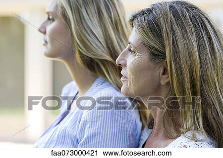 Mother and grown-up daughter, side view View Large Photo Image Stock Image - Mother and grown-up daughter, side view. Fotosearch