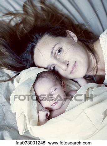 Stock Photography - Mother and her sleeping new born baby, portrait. Fotosearch