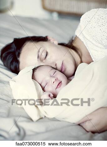 Mother and new born baby sleeping in bed View Large Photo Image Stock Photography - Mother and new born baby sleeping in bed. Fotosearch