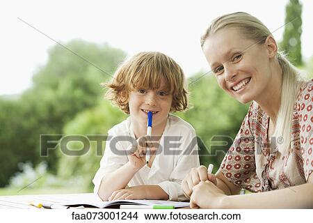 Mother and son coloring together, portrait View Large Photo Image Picture - Mother and son coloring together, portrait. Fotosearch