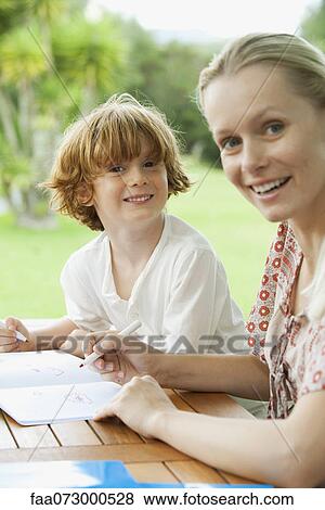 Mother and son coloring together View Large Photo Image Stock Photo - Mother and son coloring together. Fotosearch