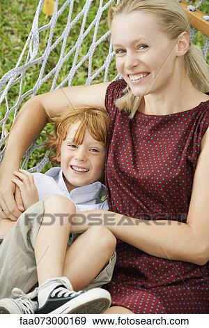 Stock Photo - Mother and son relaxing on hammock, portrait. Fotosearch