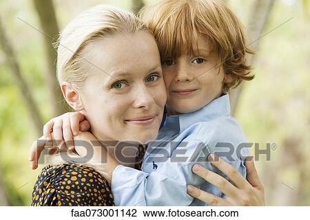 Stock Image - Mother and young son embracing, portrait. Fotosearch