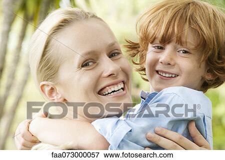 Mother and young son embracing, portrait View Large Photo Image Stock Photo - Mother and young son embracing, portrait. Fotosearch