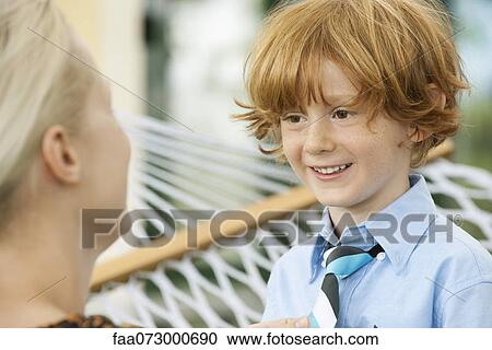 Mother helping little boy put on neck tie, cropped View Large Photo Image Stock Image - Mother helping little boy put on neck tie, cropped. Fotosearch