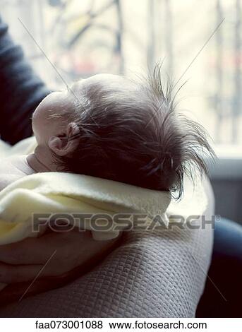 Stock Photo - Mother holding new born baby, cropped. Fotosearch