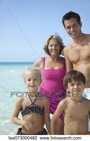Stock Image - Multi-generation family at the beach, portrait. Fotosearch