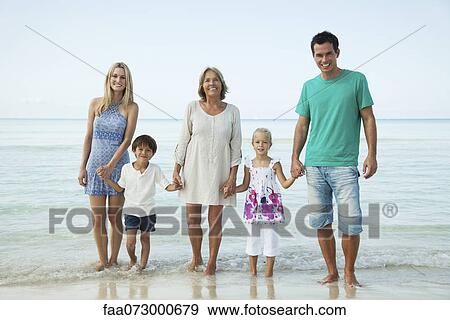 Stock Photo - Multi-generation family at the beach, portrait. Fotosearch