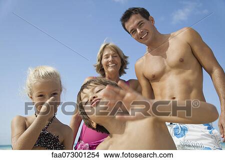 Picture - Multi-generation family having fun at the beach. Fotosearch